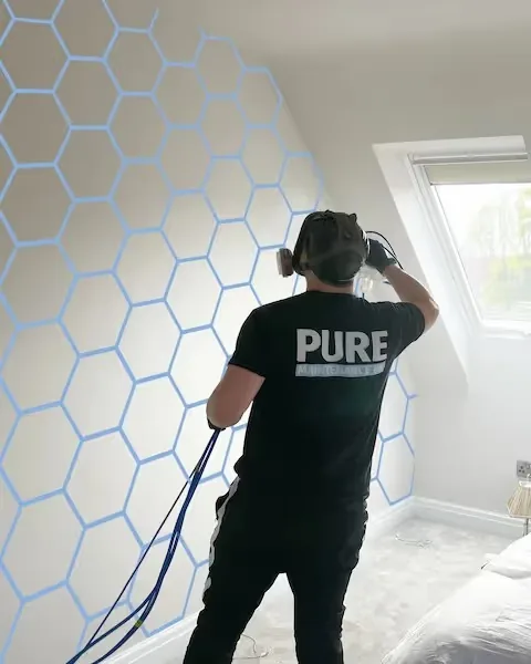 Antimicrobial film being applied to a bedroom wall