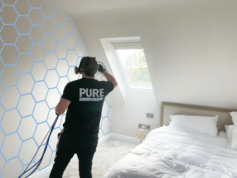 A technician applying a treatment in a bedroom