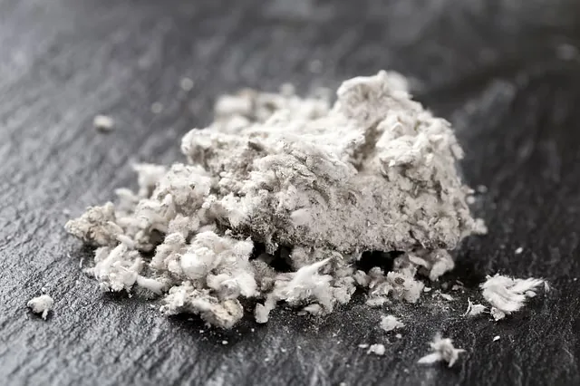 Close-up of fibrous asbestos material on a dark surface