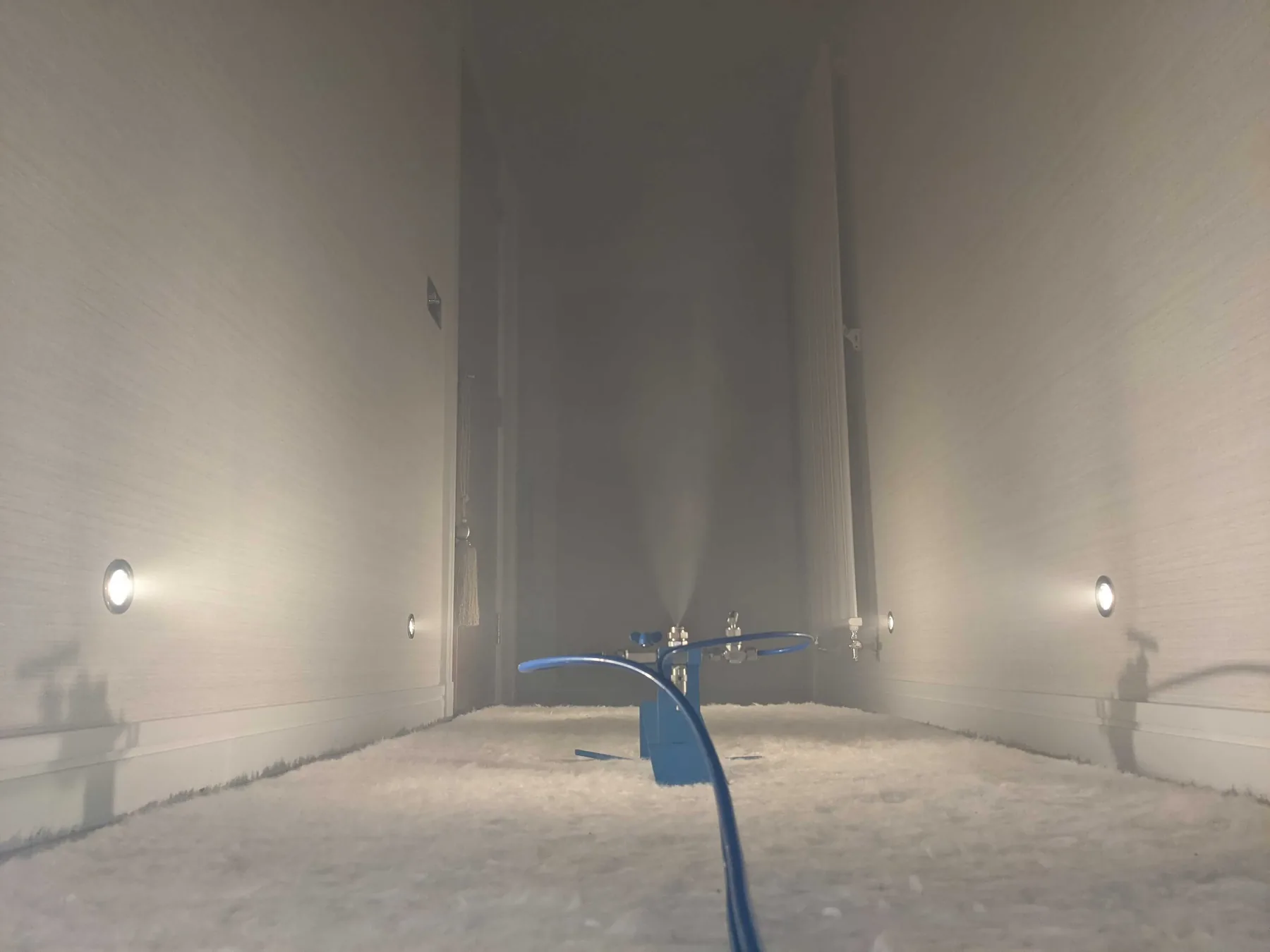 Vapor rising from a nozzle in an empty room