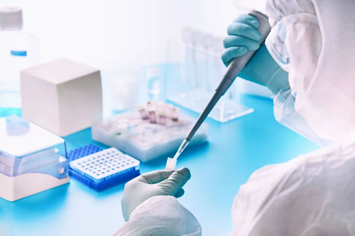 A lab technician pipetting samples