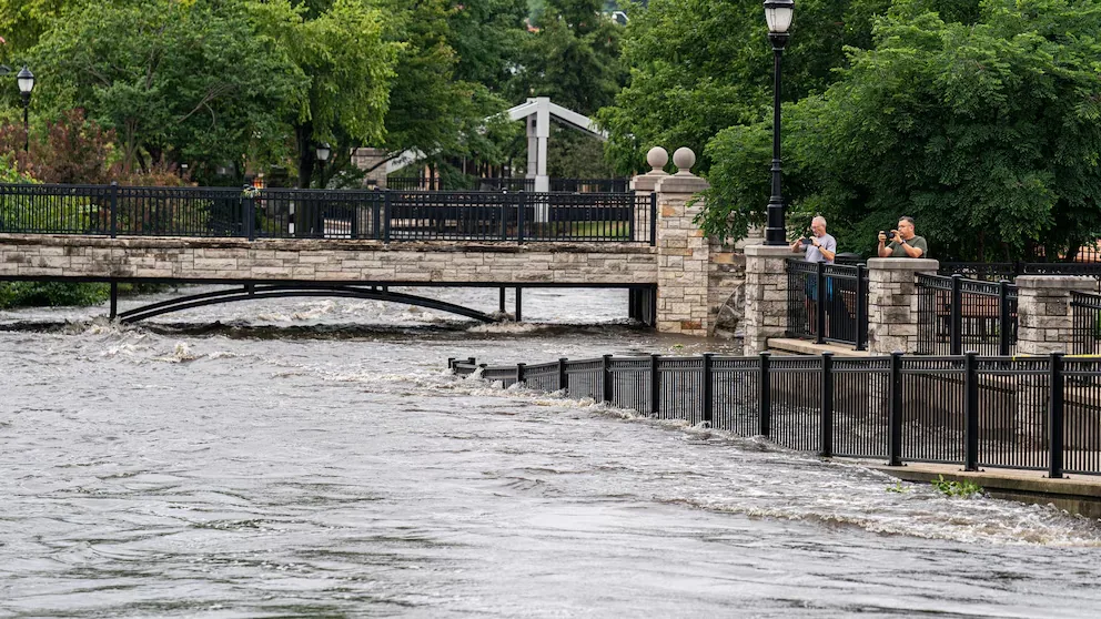 A river running high through a town during flooding