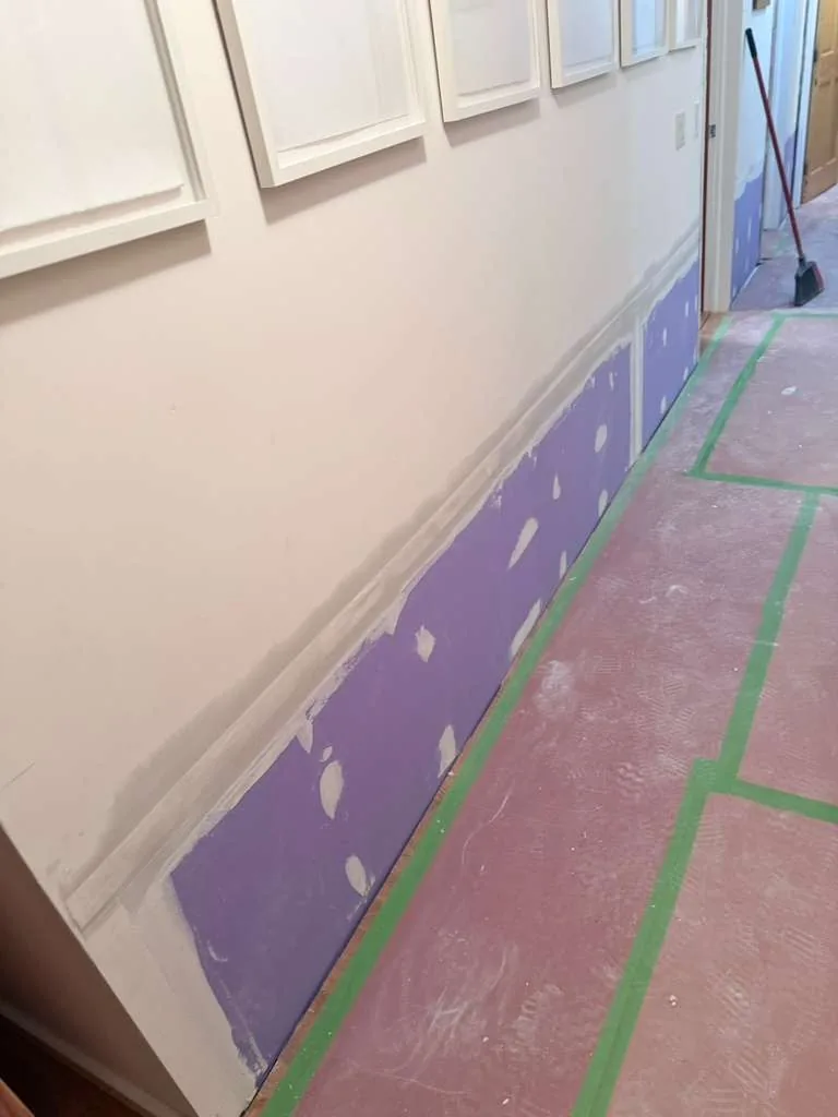 Hallway with the lower drywall cut out and replaced after mold removal