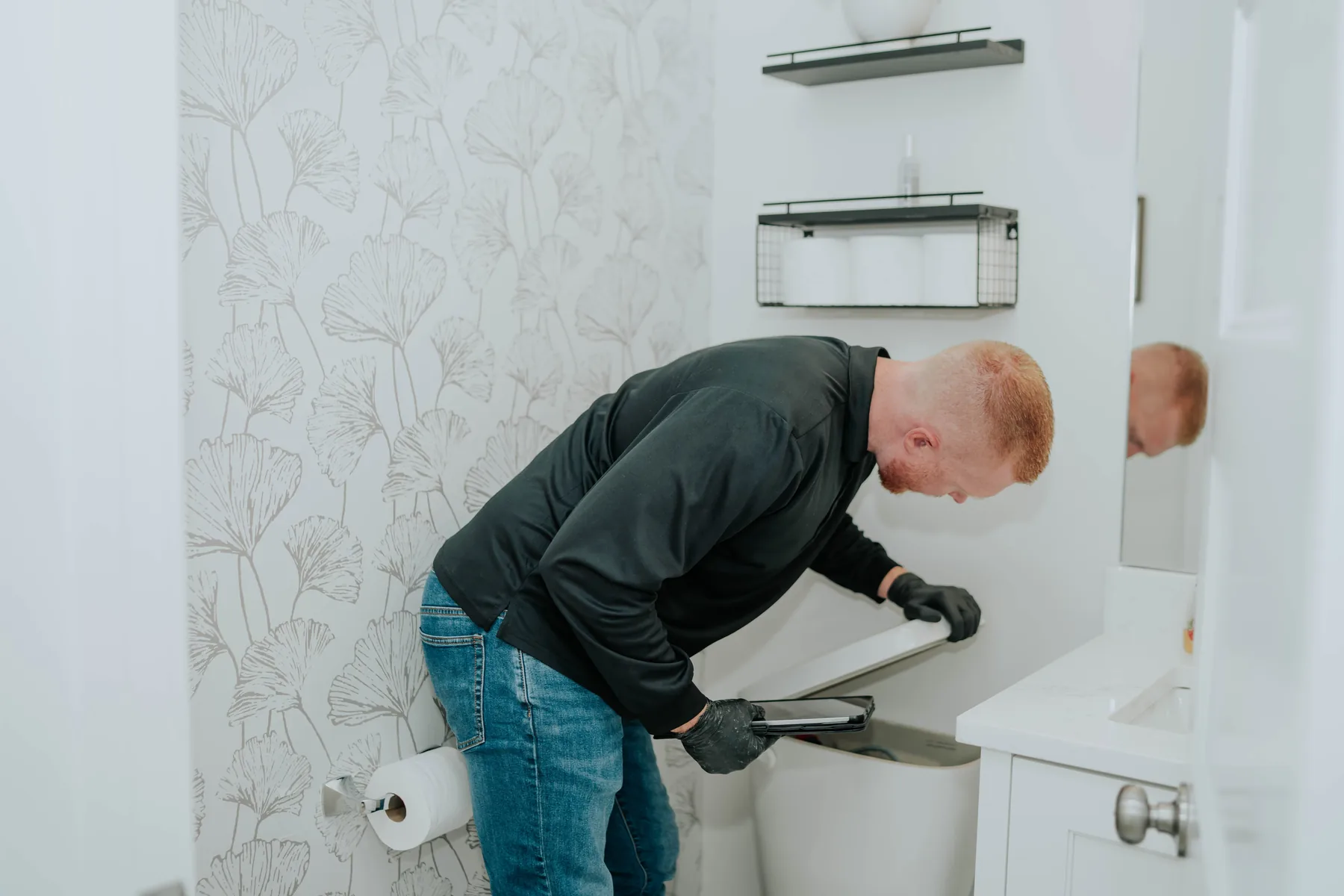 A technician inspecting a bathroom