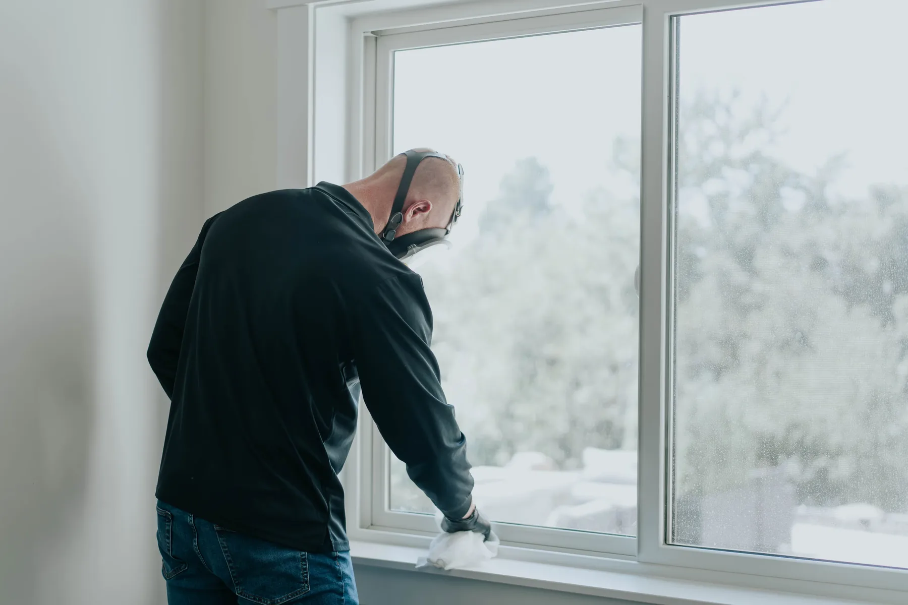 A technician inspecting a window frame